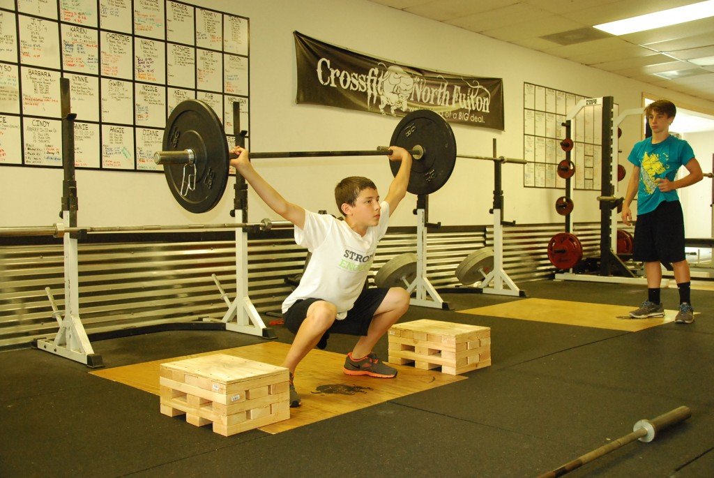 Max snatches from the blocks in the CrossFit North Fulton Weightlifting Summer Camp.